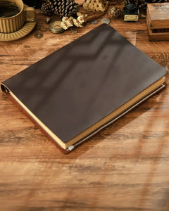 Dark brown Legacy Binder A4 journal on a wooden desk