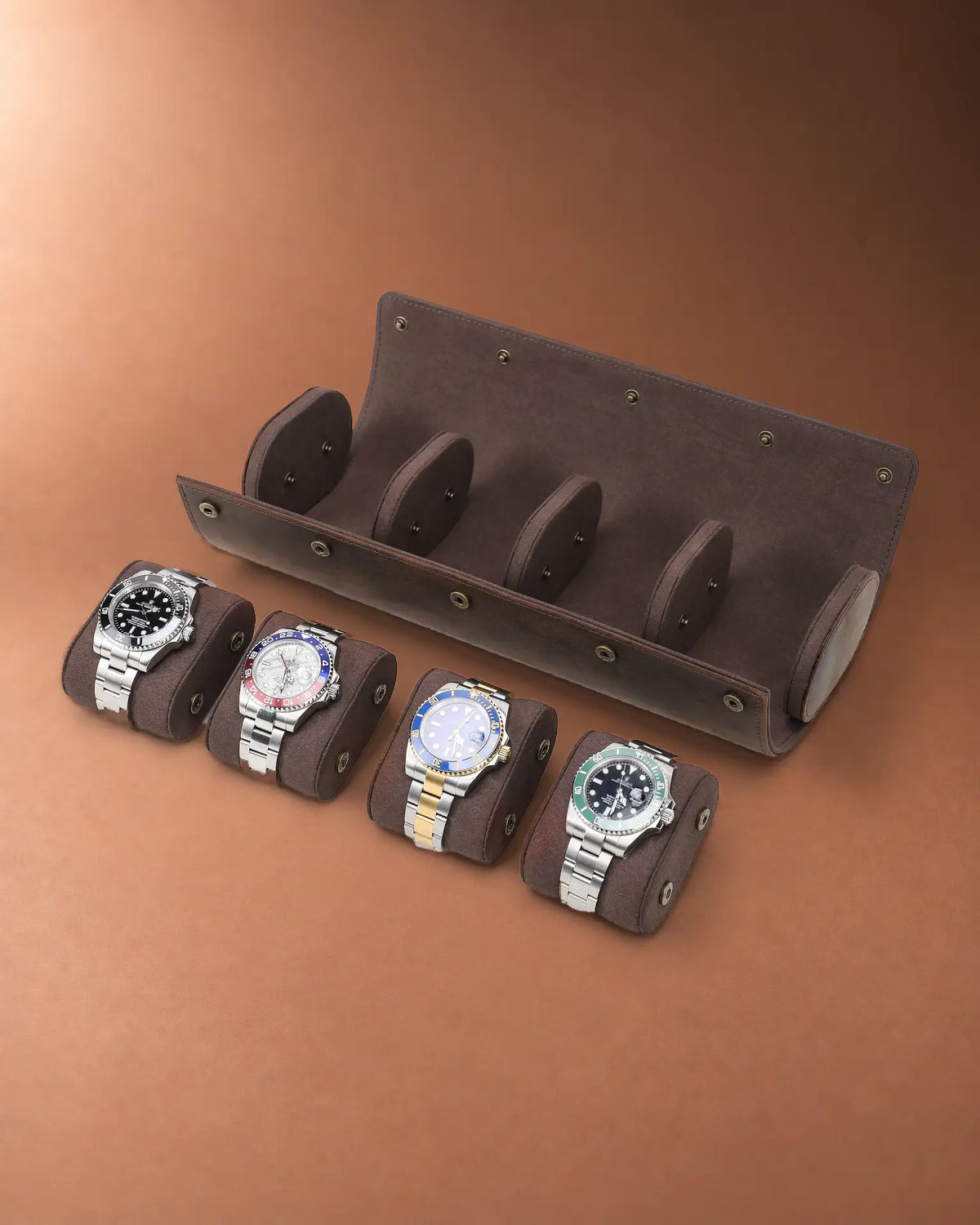 Four removable watch cushions displayed in front of the open Espresso watch roll.