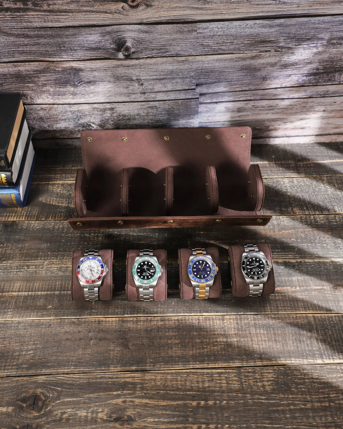 Top view of the empty four-watch roll with all four removable cushions displayed below it.