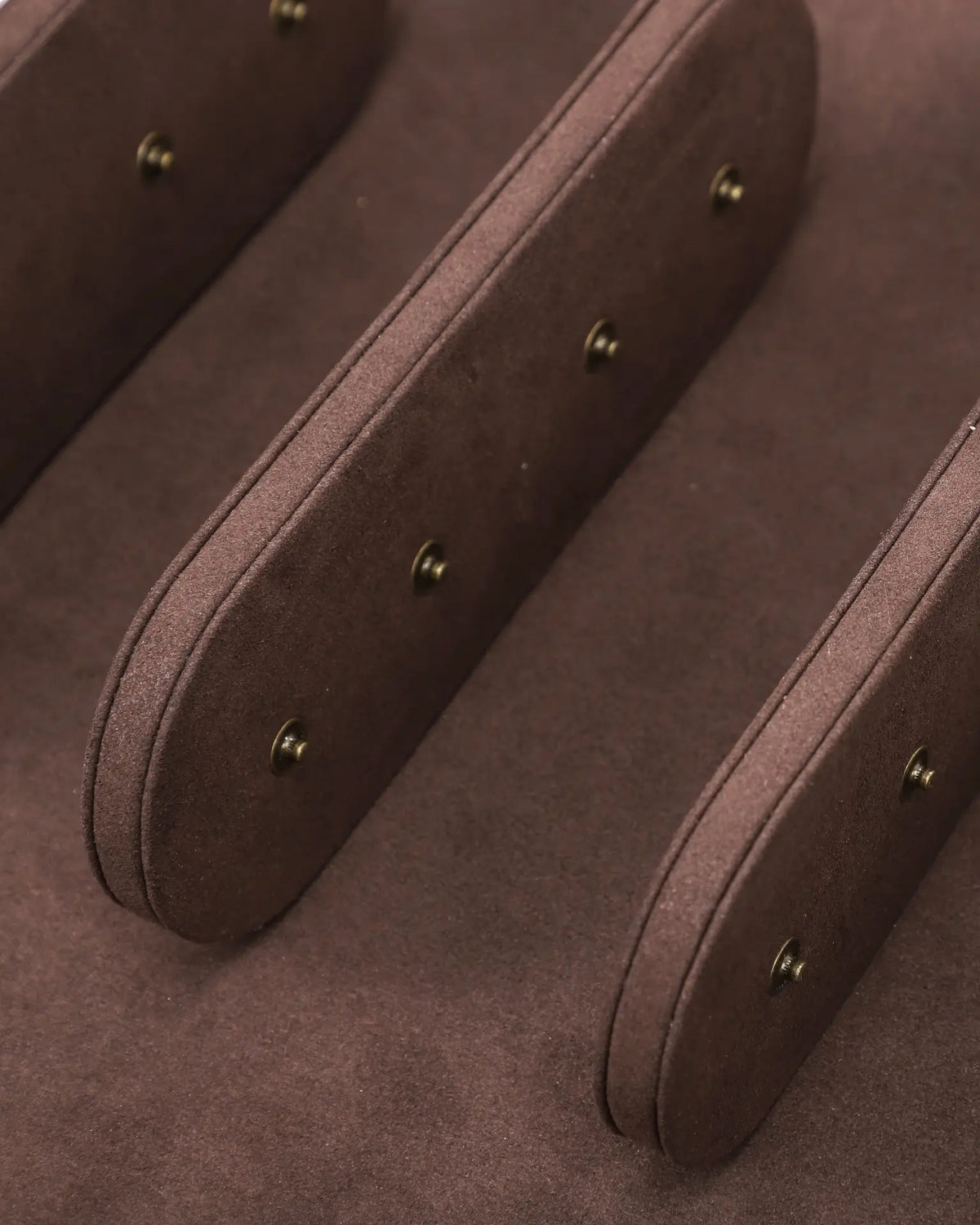 Close-up of the brown interior dividers and cushion snap fittings inside the six-watch case.