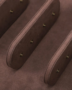 Close-up of the brown interior dividers and cushion snap fittings inside the six-watch case.