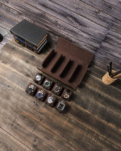 Top view of the empty eight-watch case with eight removable watch cushions displayed in front.
