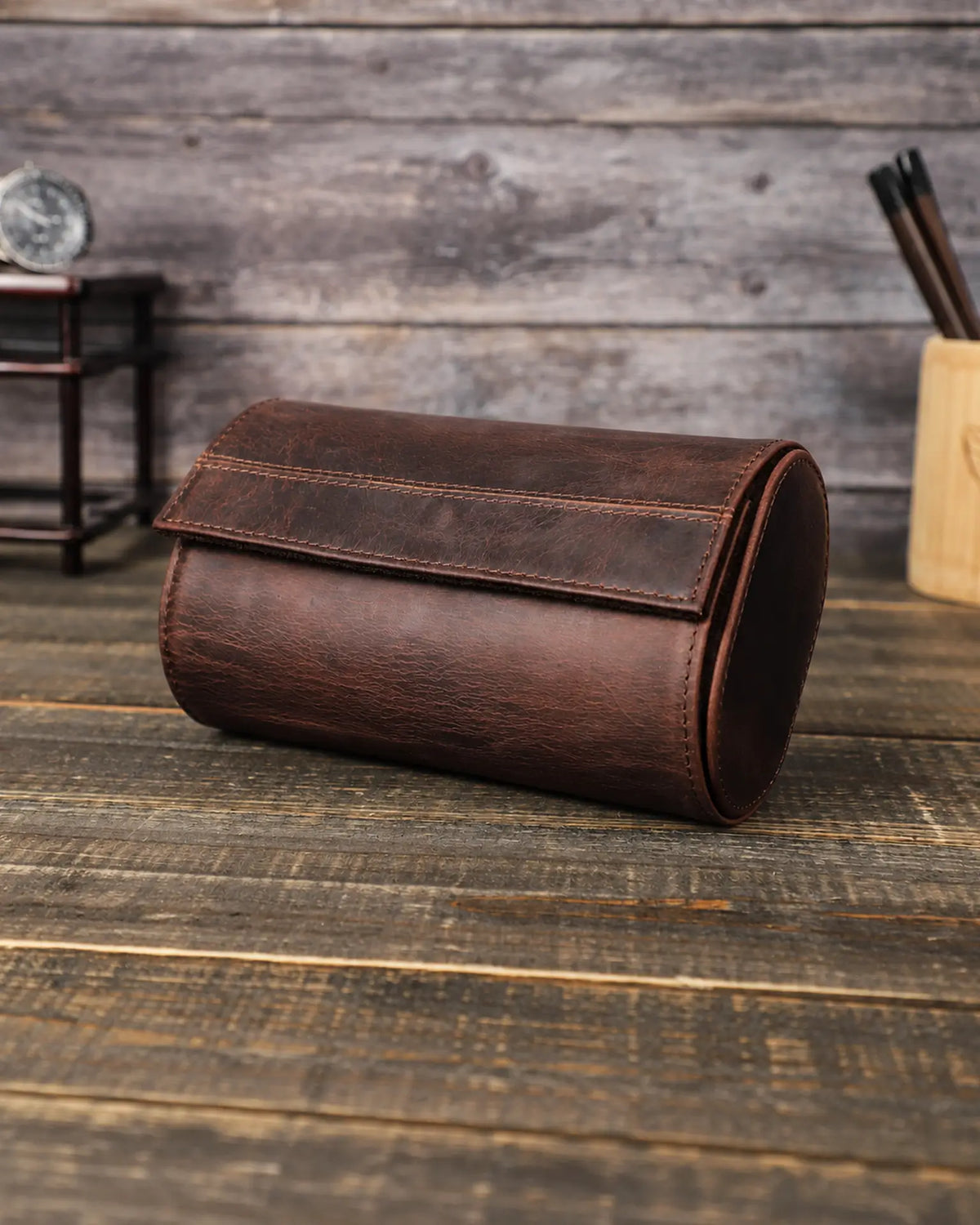 Closed Espresso double watch roll at an angle, showing its curved flap and stitched leather sides.