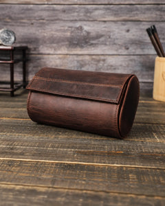 Closed Espresso double watch roll at an angle, showing its curved flap and stitched leather sides.