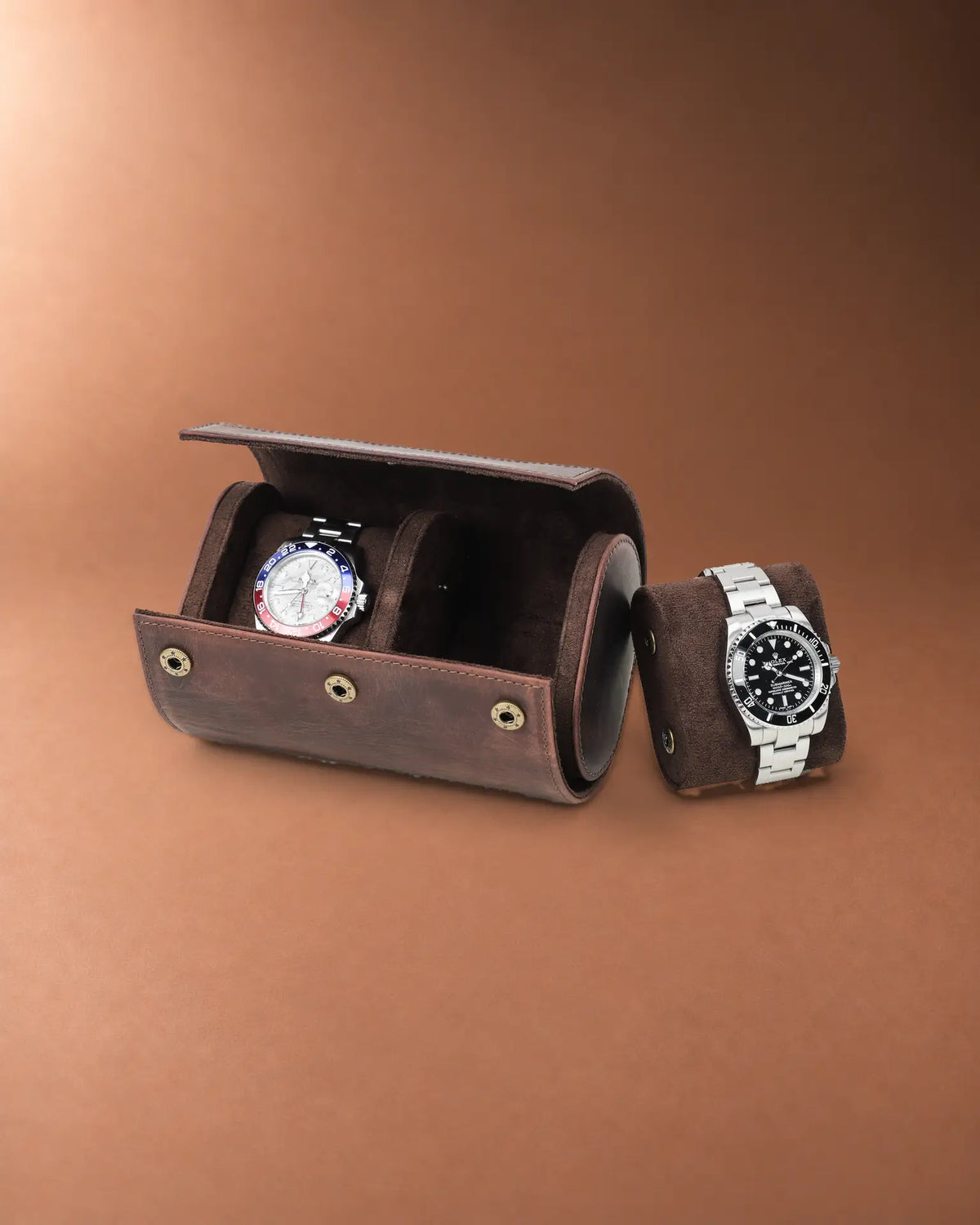 Open double watch roll with one watch inside and a second watch on a removable cushion beside it.