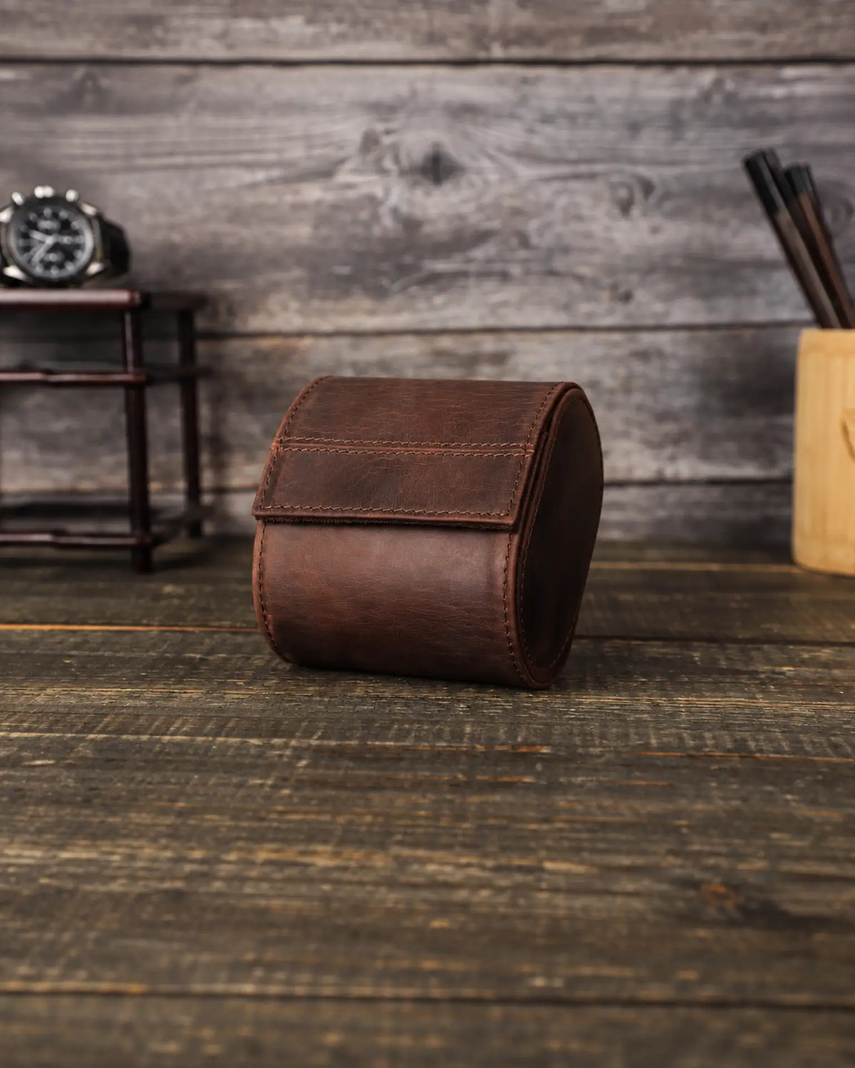 Front view of the closed Espresso watch roll, showing the curved flap and stitched leather exterior.