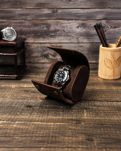 Angled view of the Espresso watch roll opened around a watch on a wooden tabletop.