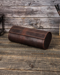 Closed Espresso triple watch roll at an angle, showing the long curved flap and stitched sides.
