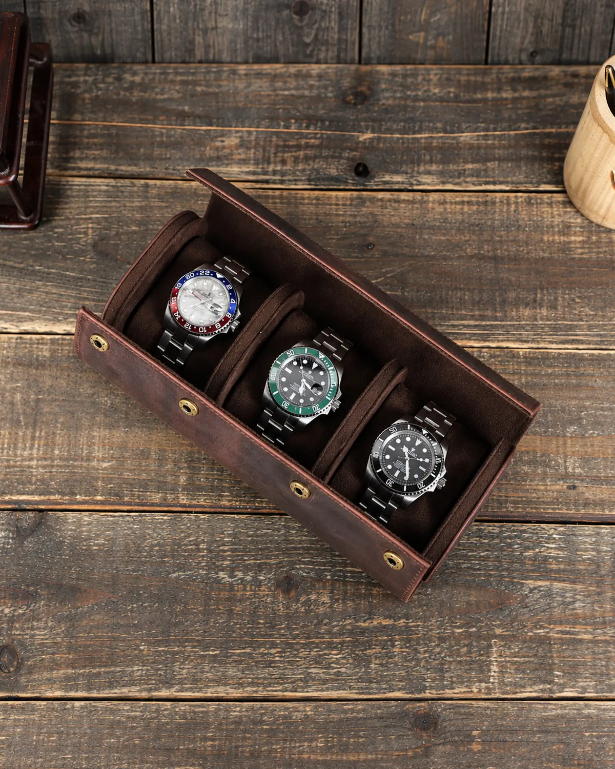 Top view of the open triple watch roll with three cushions separated by two interior dividers.