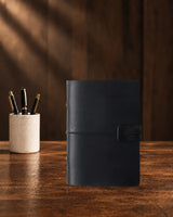 Black Legacy Loop A7 leather ring-binder journal with a plain cover and wrap closure