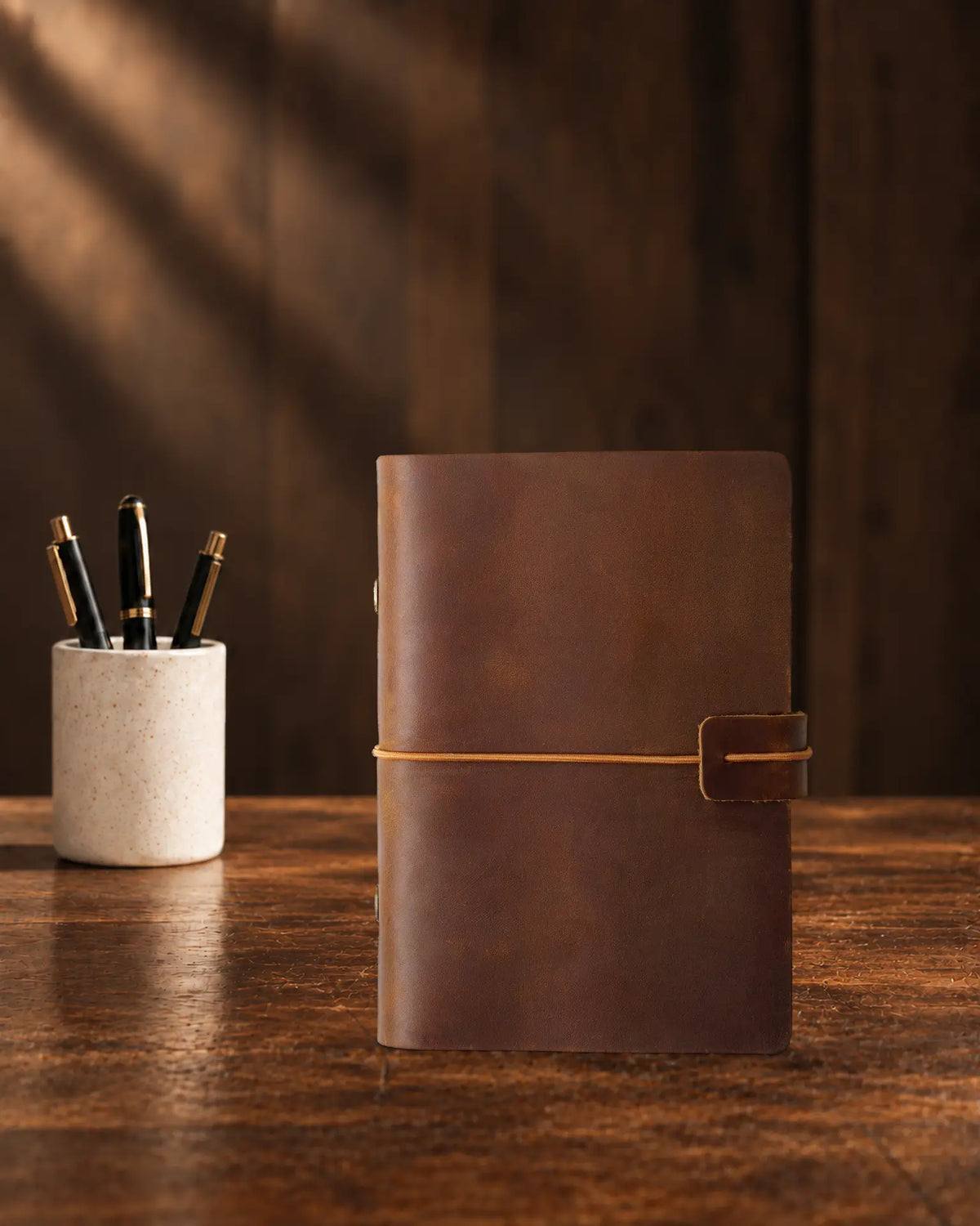 Cognac Legacy Loop A7 leather ring-binder journal with a plain cover and wrap closure