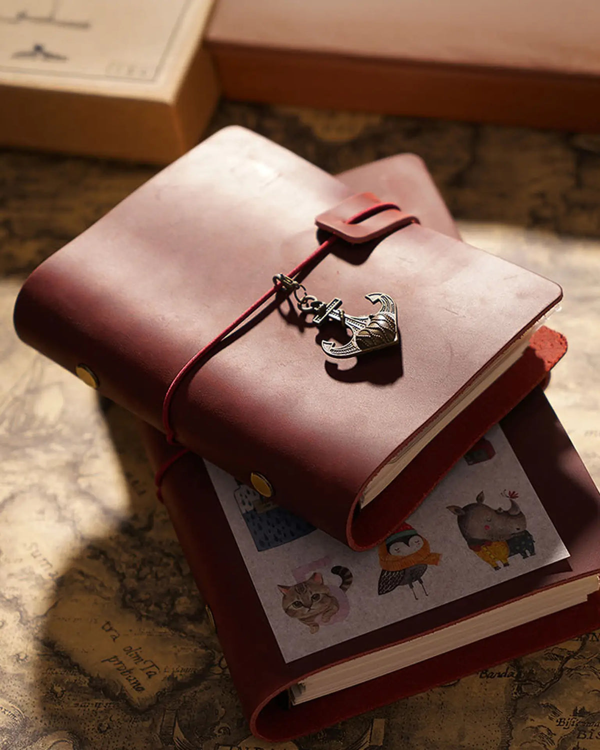 Small Crimson Legacy Loop journal on a larger journal; charms and styling props not included