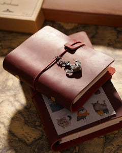 Small Crimson Legacy Loop journal on a larger journal; charms and styling props not included