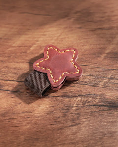 Crimson leather star magnetic bookmark with contrast stitching and elastic pen holder