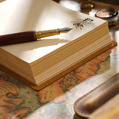 Fountain pen on an open notebook with a world map in the background