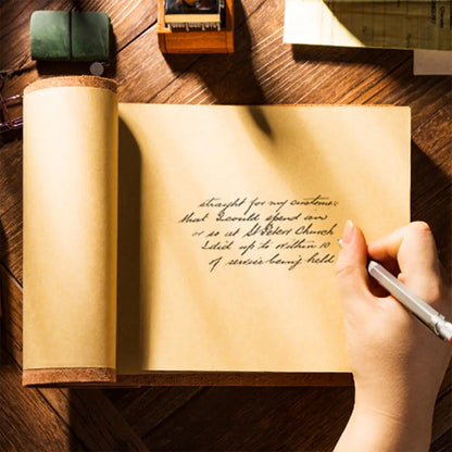 Handwritten text on a leather-bound book with a pen and stamp on a wooden surface