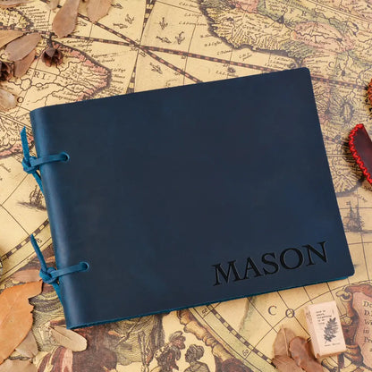 Blue notebook with 'MASON' embossed on it, placed on an old map.