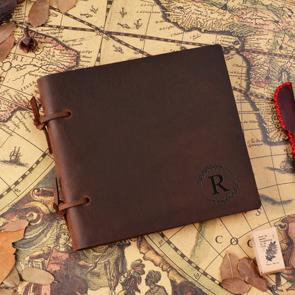 Brown leather notebook with a monogram on an old map background