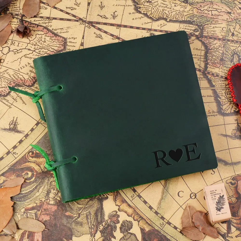 Green notebook with 'Roe' embossed on it, placed on an old map.