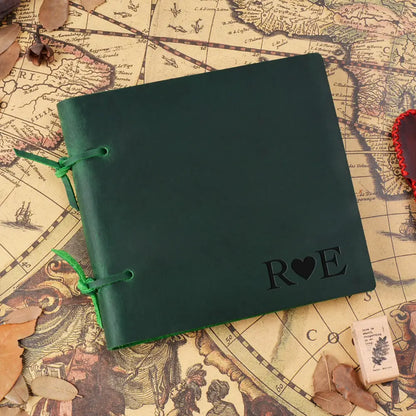 Green notebook with 'Roe' embossed on it, placed on an old map.