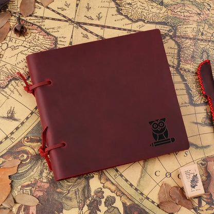 Red notebook with owl emblem on a vintage map background