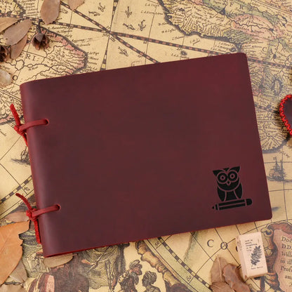Maroon notebook with owl design on a vintage map background