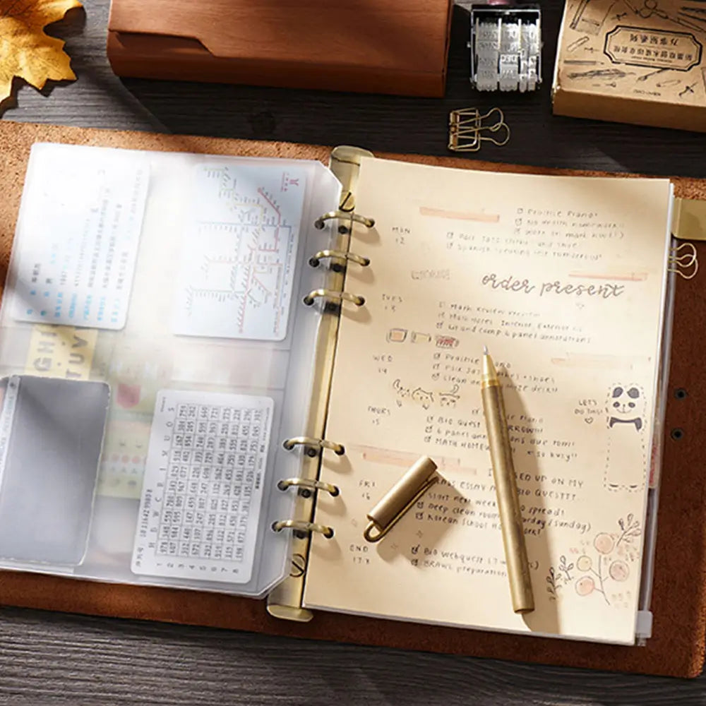 Open planner with notes and a pen on a wooden desk