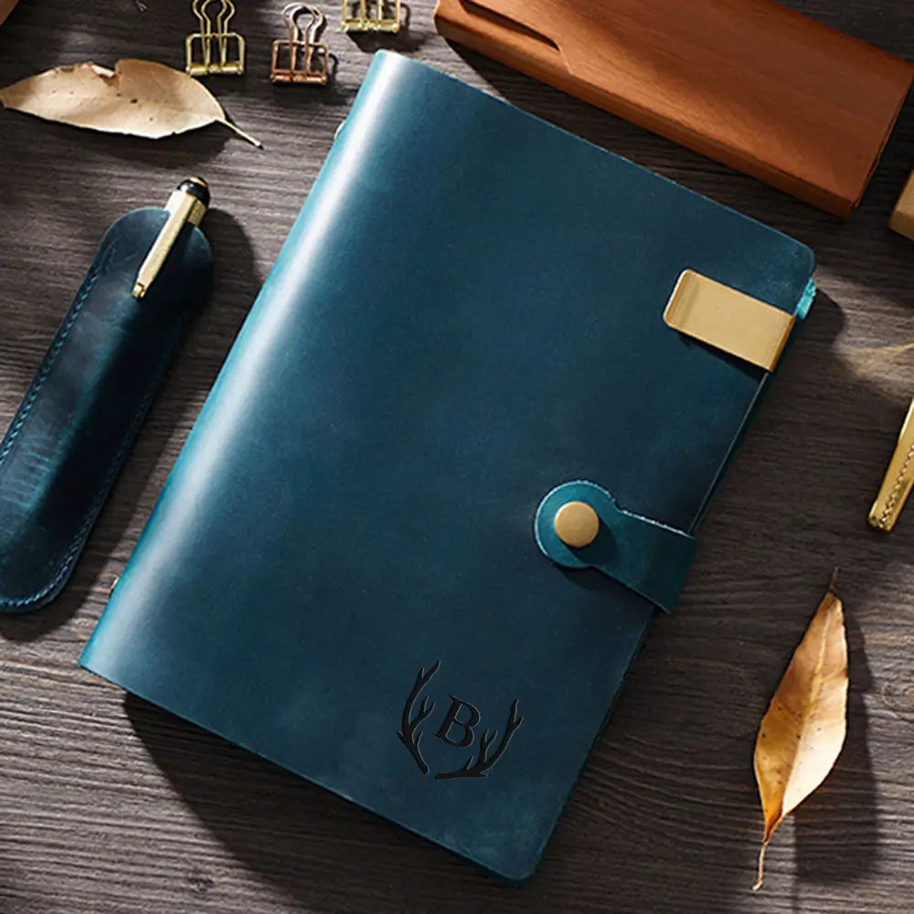 Blue leather notebook with gold accents on a wooden surface