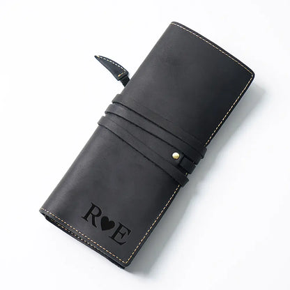 Black leather pen case with 'RVE' engraving on a white background