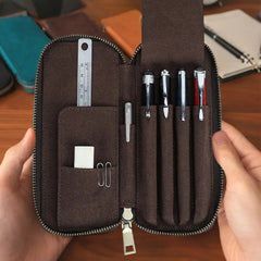 Four fountain pens in handmade leather pen case
