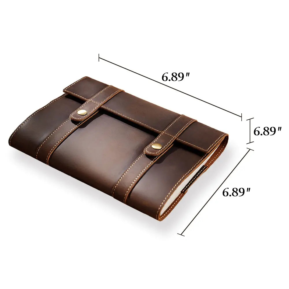 Brown leather notebook with dimensions indicated on a white background