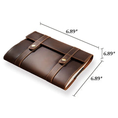 Brown leather notebook with dimensions indicated on a white background